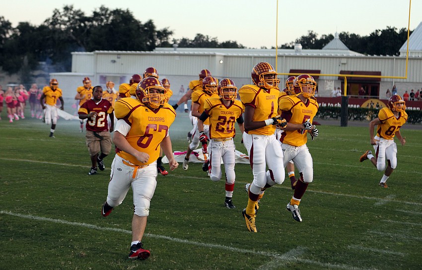 The Cardinal Mooney football players make their way out onto the field before the start of their homecoming game against St. Petersburg Catholic Friday, Oct. 12.