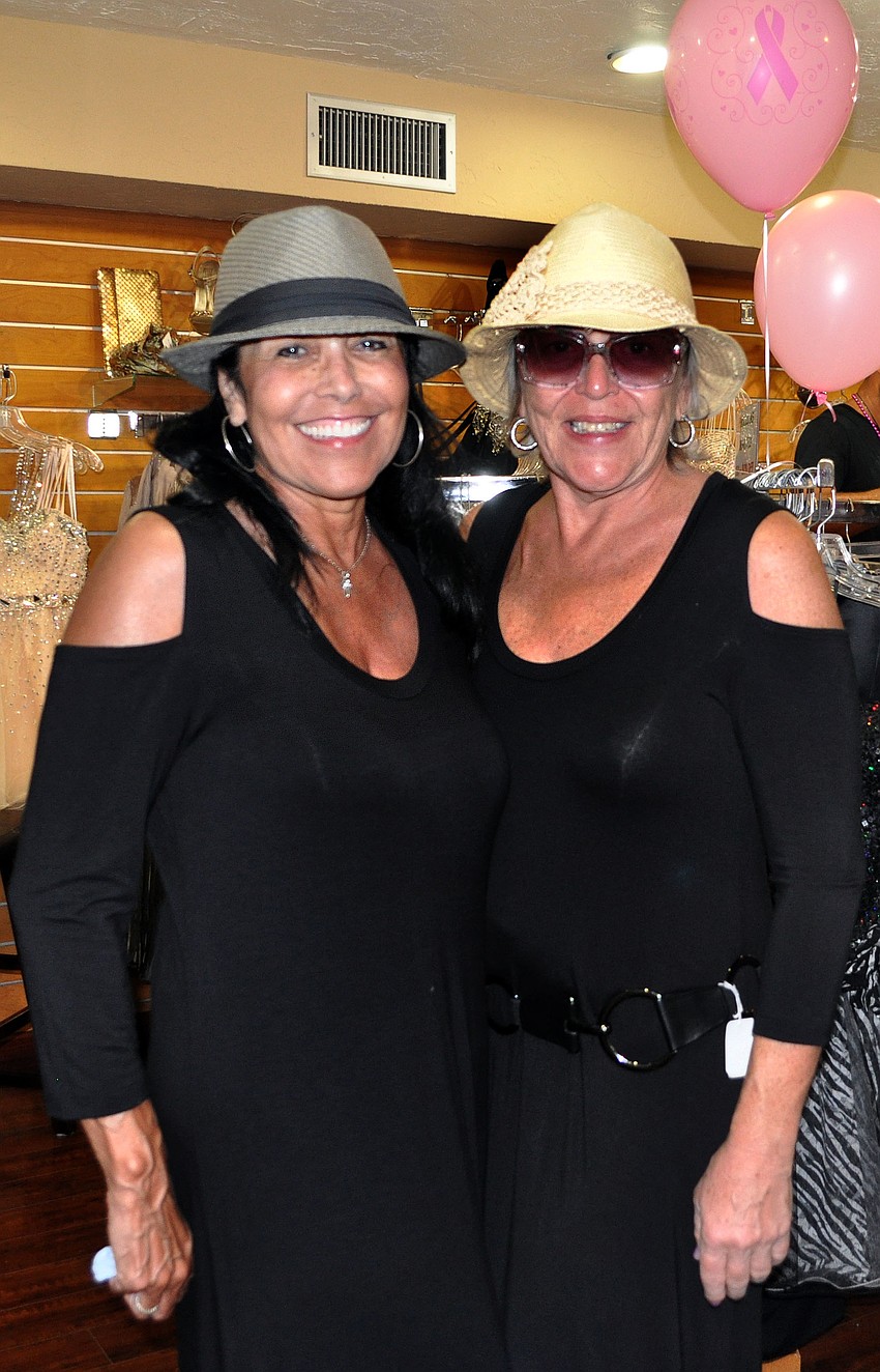 Elaine Allen and Dawn Romero try on some dresses and hats at Foxy Lady Sunday, Oct. 14, during the Martinis and Makeovers event on Siesta Key.