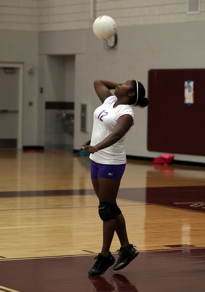 Kellisha Bellamy, No. 12, serves to the Lady Rams.
