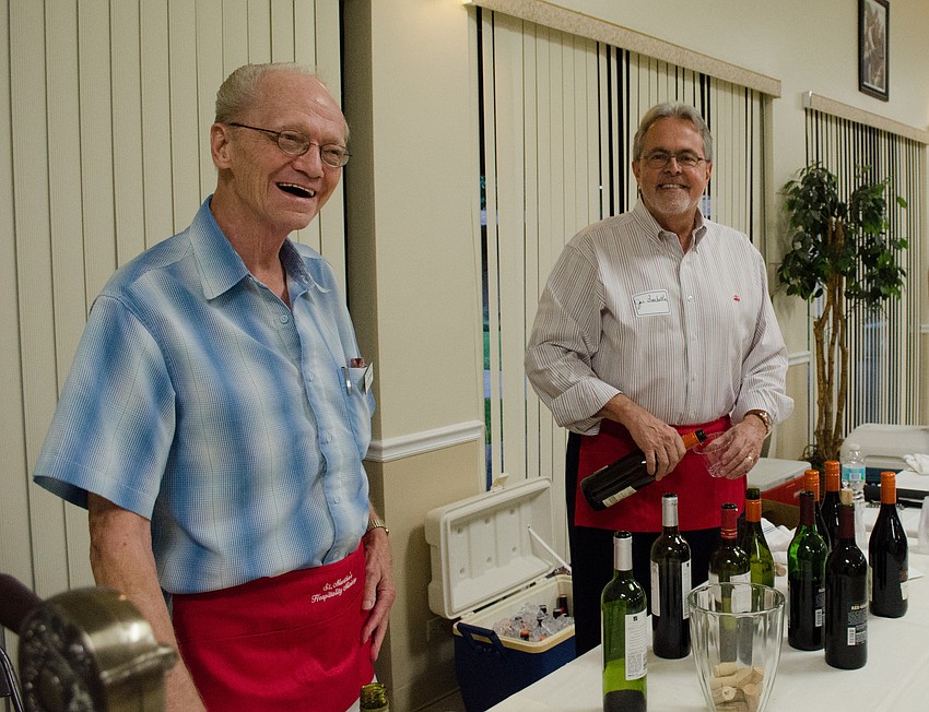 Bill Konopaste and Joe Barbetta serve wine to parish members.