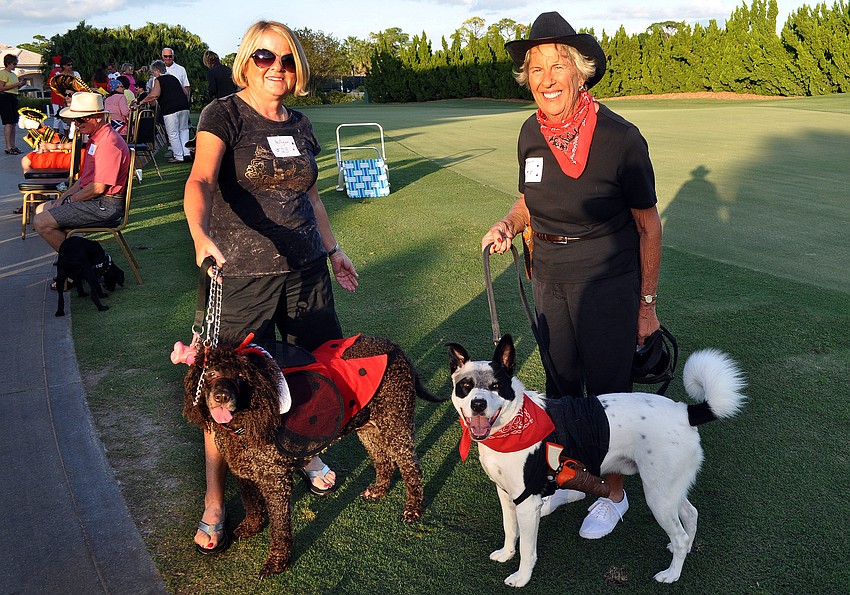 Gari Baker with her dog Mulligan, 10, and Nancy Fletcher with her dog Bandit, 5, at the 2nd annual Halloween Doggie Parade at Stoneybrook Golf and Country Club in Palmer Ranch.