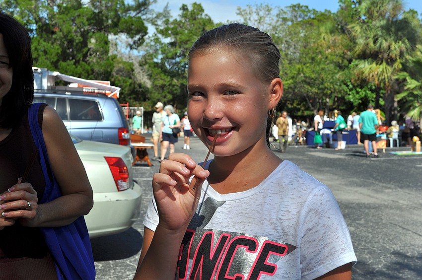 Micah Barnes, 10, tries key lime honey from the Winter Park Honey tent.