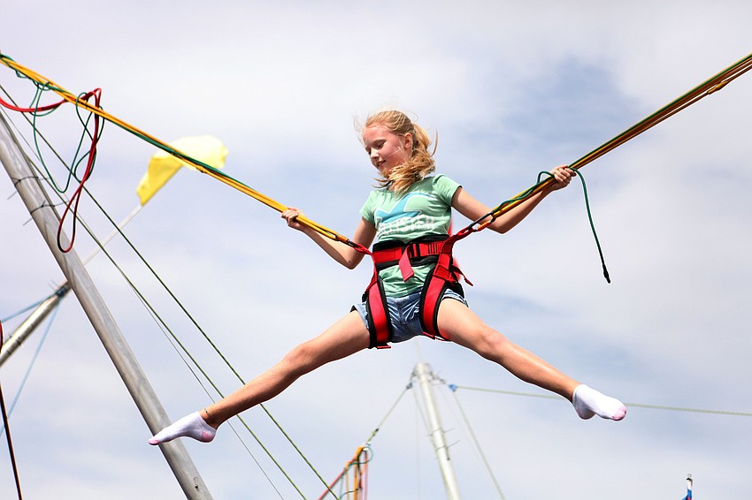 Alana Anderson, 8, has fun jumping up and down and doing splits in the air Saturday, Oct. 27, at the Sarasota Pumpkin Festival.