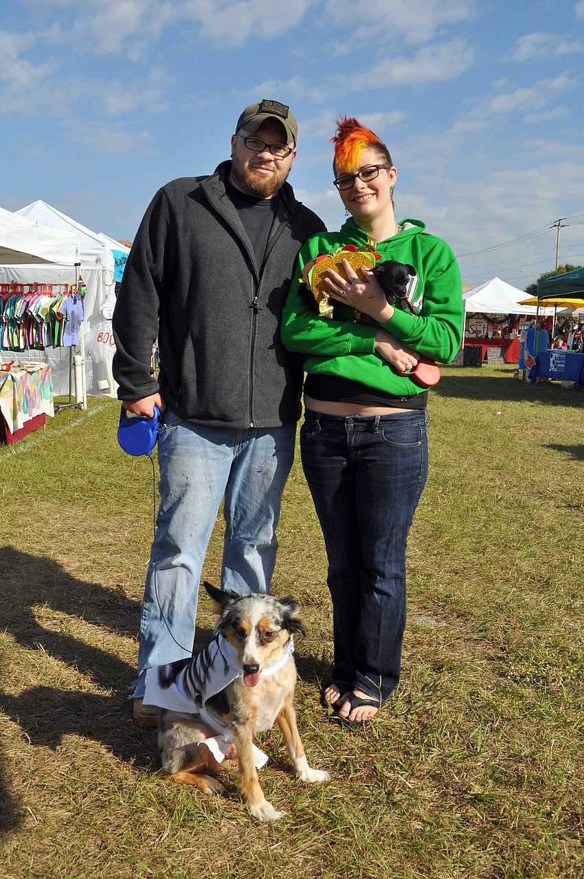 Kim Albers with his dog Cody, 7, dressed as a skeleton and Liz Struebing with her dog Cricket, 3, dressed as a taco.