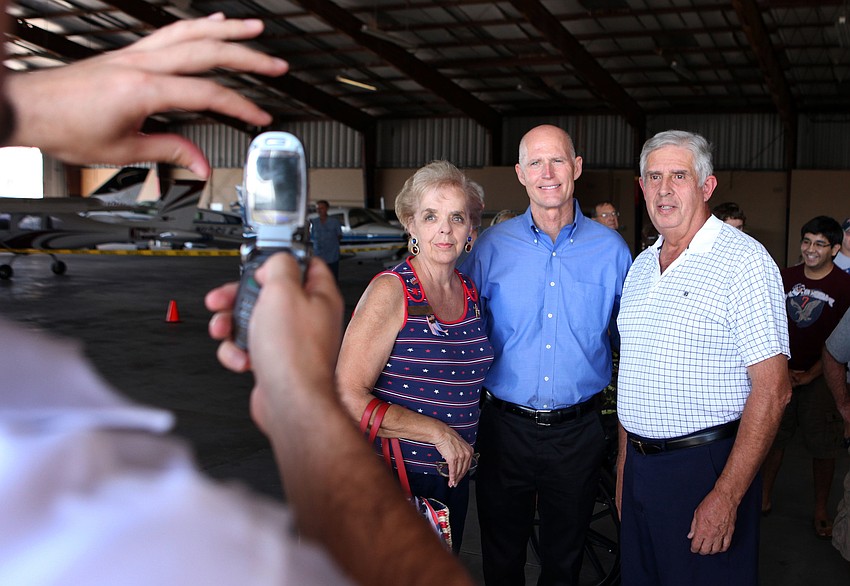Cathy and Chuck Faust get a photo with Gov. Rick Scott taken on their cellphone.