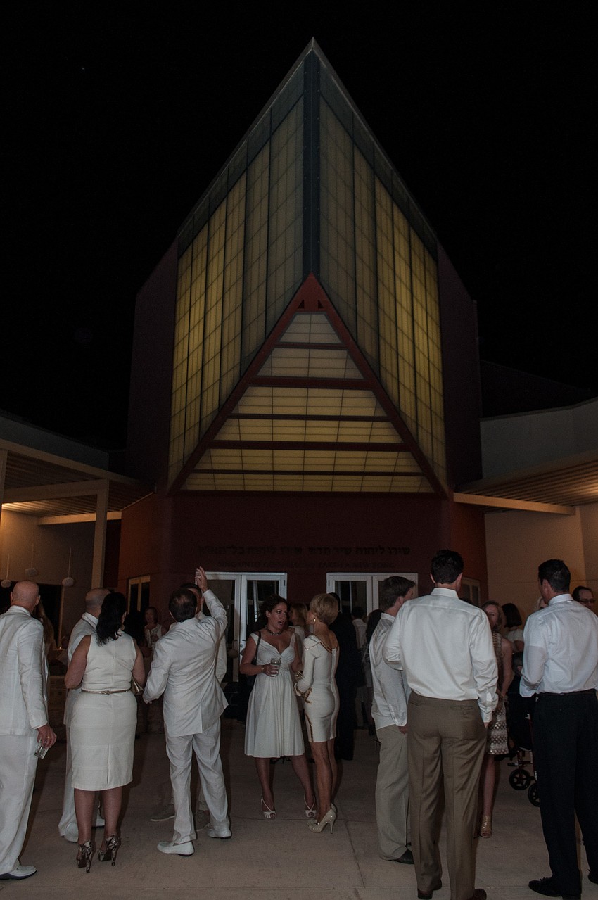 Partygoers mingled and bid on silent auction items before entering the main room.