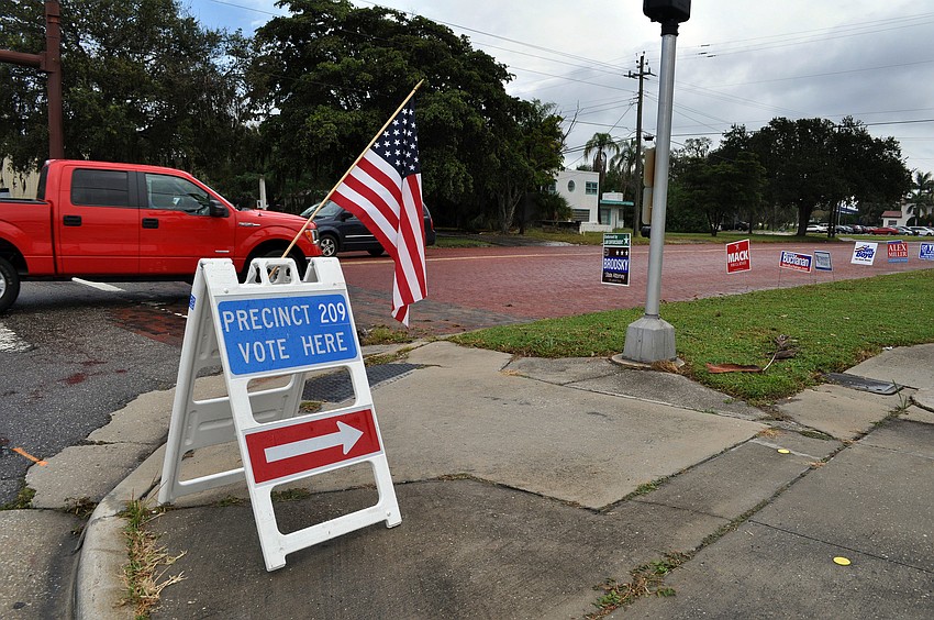 Signs promoting candidates line Oak Street where one of the many polling places is located Wednesday, Nov. 6, Election Day.