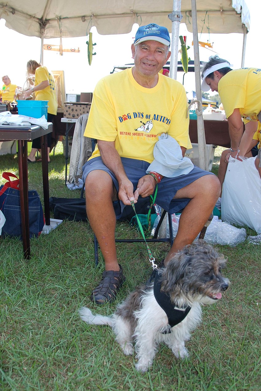 Michael Pattison, a volunteer for the Humane Society of Lakewood Ranch, sits with his foster dog that he put up for adoption.