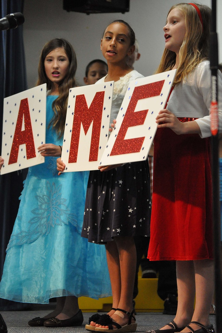 Elizabeth Mateus-Norskov, Hannah McFarland and Maggie Donnelly helped spell out 