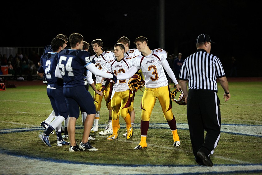 The captains from both The Out-of-Door Academy and Cardinal Mooney shake hands before the game.