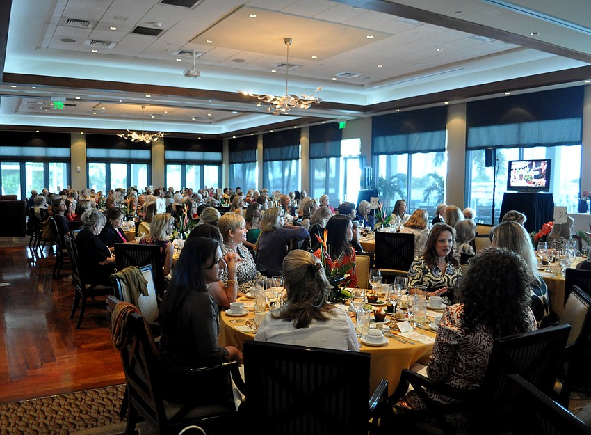 Attendees watch as Ariella Chezar demonstrates floral arrangements.
