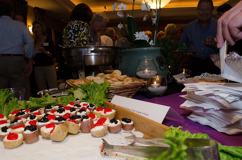 Neighbors snacked on mini potatoes with caviar and sour cream.