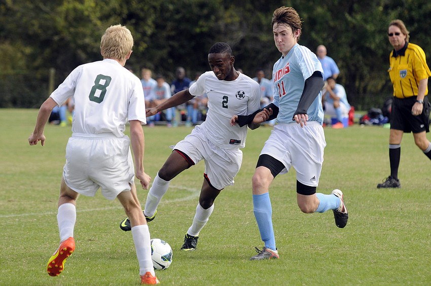 Lakewood Ranchâ€™s Schmid Payen attempts to maneuver the ball past a Tampa King defender and pass it up to Ben Wilson.