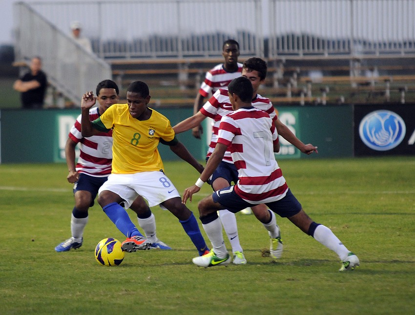 Several U.S. players converge on a Brazilian forward during the first half.