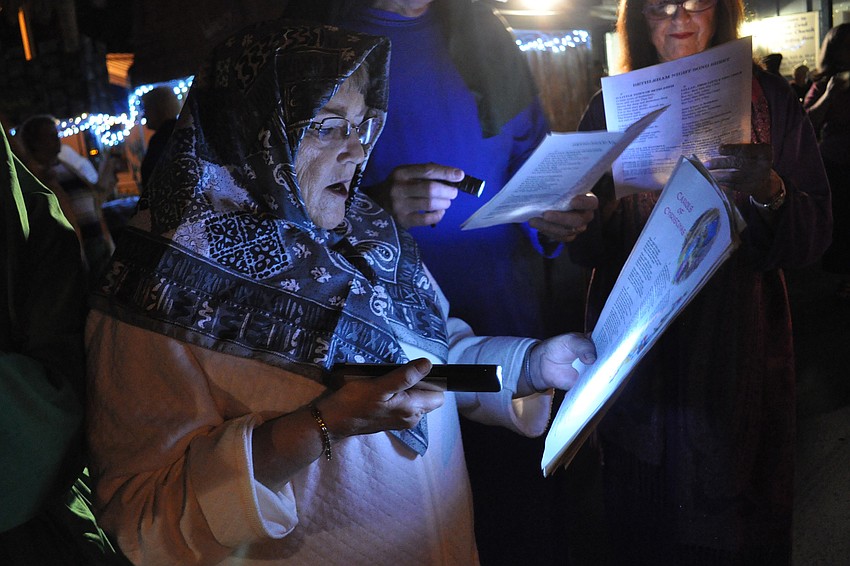 Barbara Miller and other villagers sang Christmas carols.