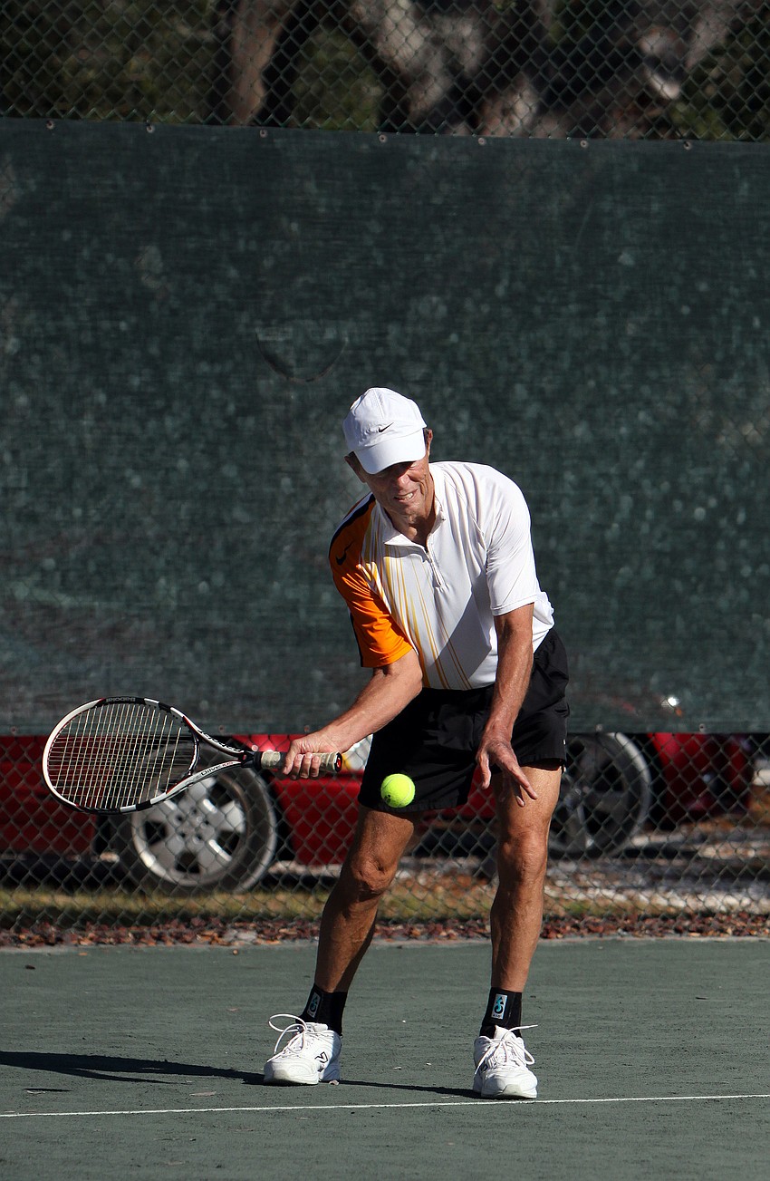 Andy Adams goes for a forehand shot during his mixed doubles match.