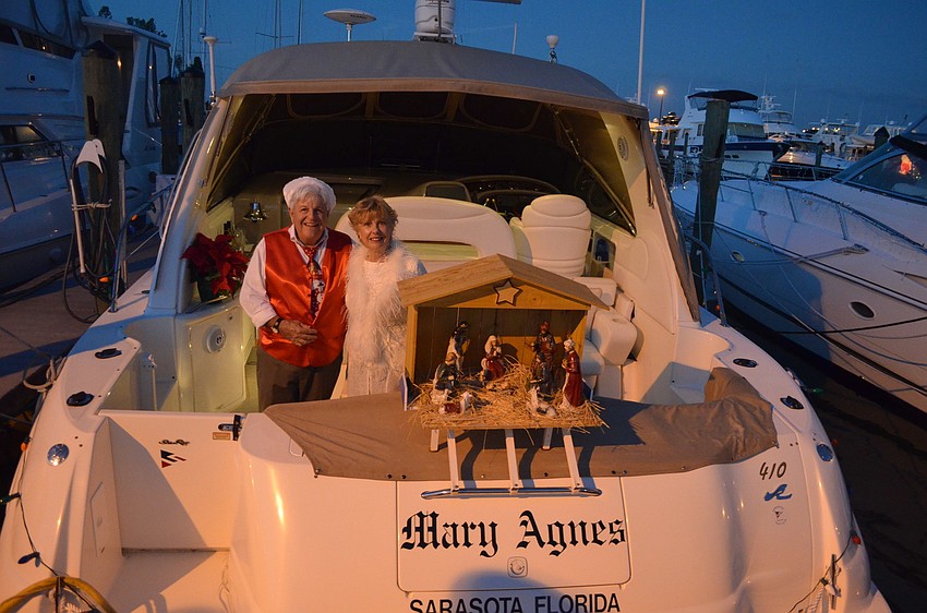 Jym Agen stands next to his wife Mary Agnes, after whom he named his yacht. Jym built the manager that sits anchored on the back.