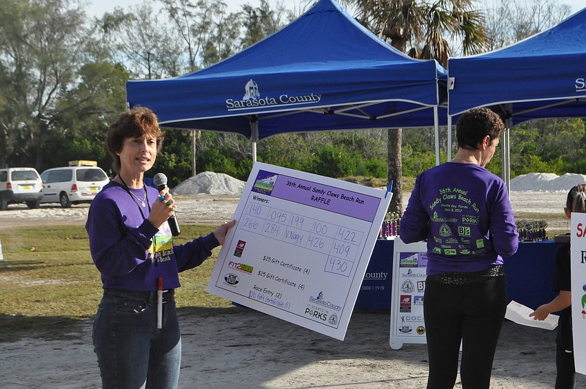 Director of Parks and Recreation Carolyn Brown calls up raffle prize winners.