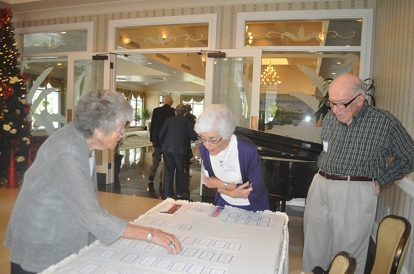Jane and Martin Albaum welcome newcomer Frances Eisner (left) to her first Democratic Club luncheon.