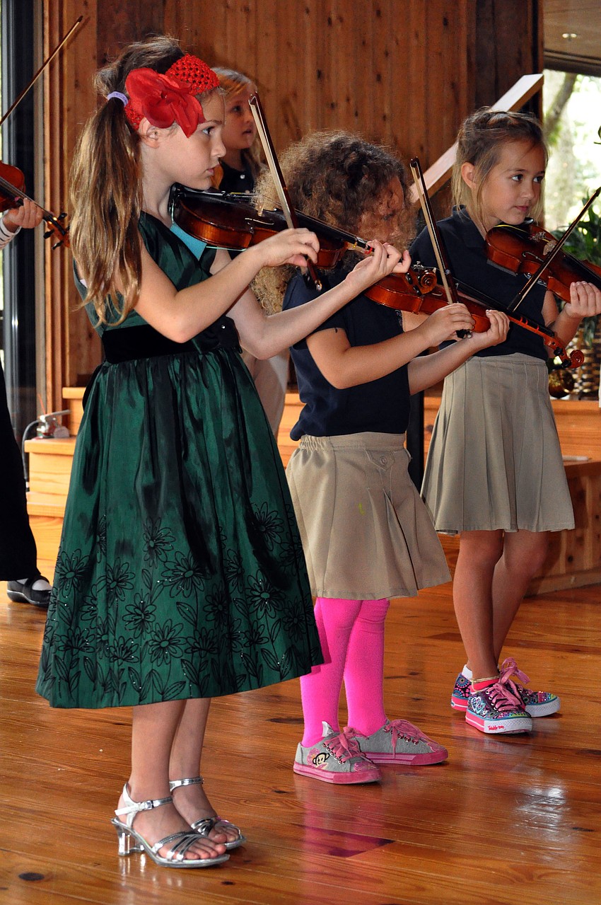Esabella Lerario, Kirin Malisoff and Fiona Sutton play their violins Tuesday, Dec. 11, during the Christmas and Holiday Music Fest at Siesta Key Chapel.