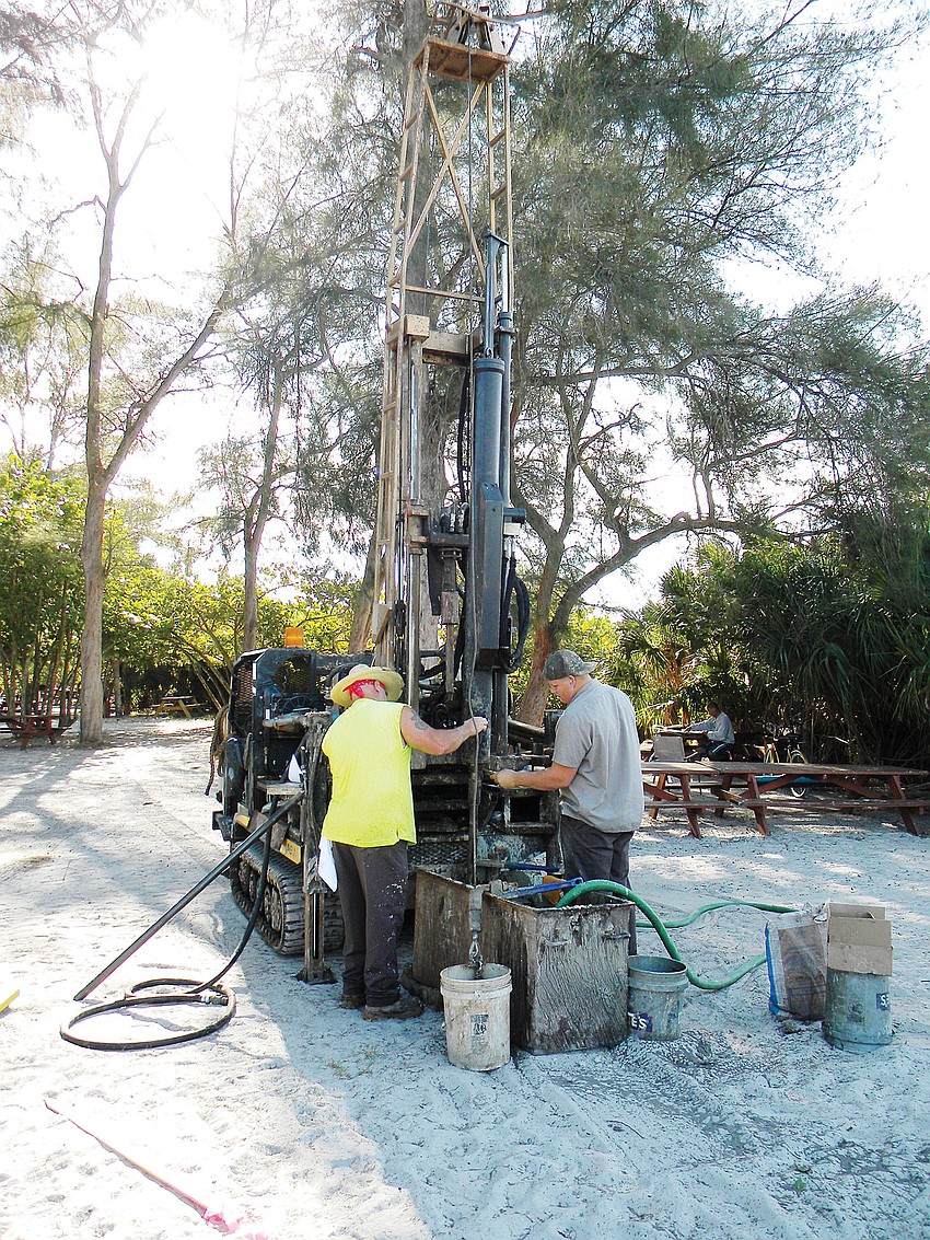 Robert Shuey and Joe Shaw, employees of Tierra Inc., check on the depth of the water table Jan. 31 in one section of the Siesta Public Beach Park for park improvements.