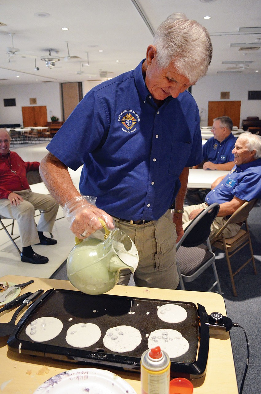 Knights of Columbus Warden Jack Burnham makes blueberry pancakes for parish members Dec. 2, at St. Michael the Archangel Catholic Church.