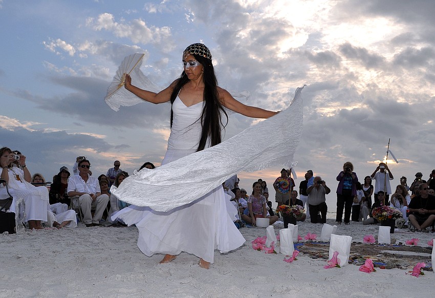 Dr. Margerite Barnett does a dance around the mandala.