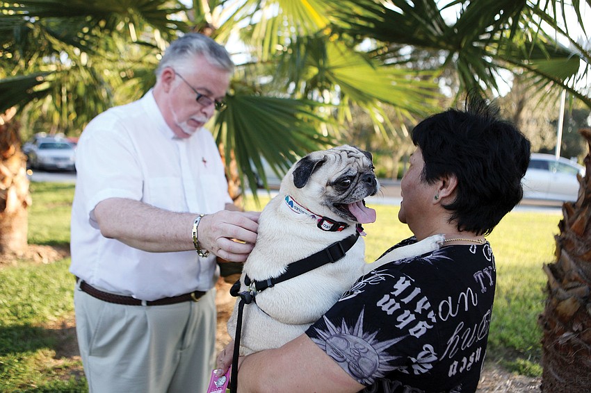 Deacon Tom Grant blesses Mary Seguerra's dog, Pugley, 2, at Our Lady of Mount Carmelâ€™s pet blessing.