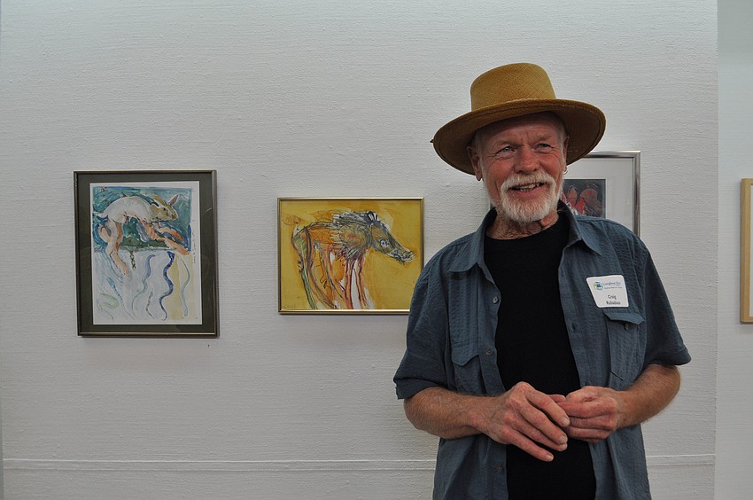 Craig Rubadoux posed in front of his painting, 