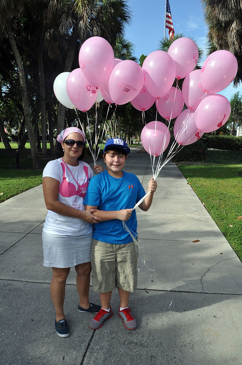 Michael Hampton helped his mom, Joanne, decorate storefronts on St. Armands Circle with pink ribbons and balloons Oct. 6 for Circle Me Pink, an event in honor of National Breast Cancer Awareness Month. More than 60 businesses participated.
