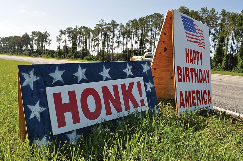 These signs, along with a military jeep, greeted drivers along State Road 70 July 4 from the Braden Pines community. Published July 12, 2012.