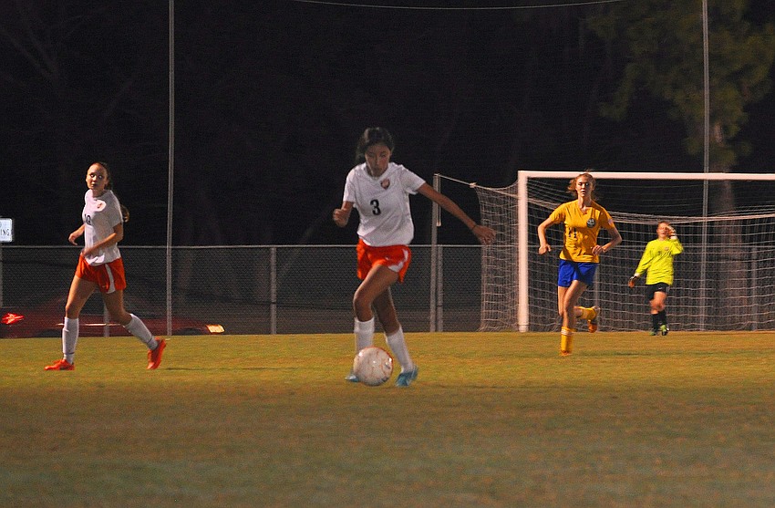 Esmeralda Gonzalez, No. 3, dribbles the ball down the field.