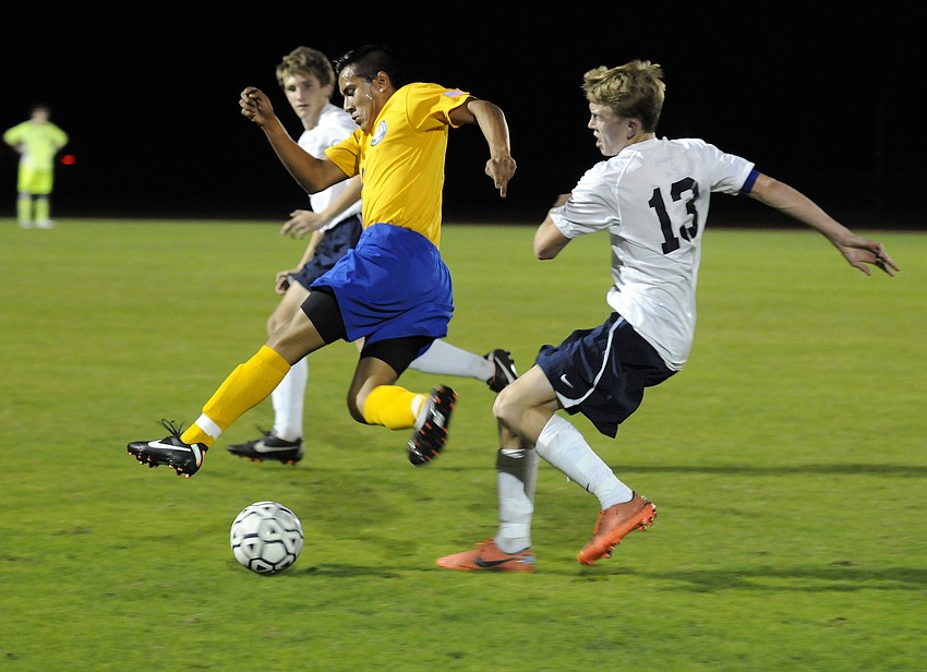 Sarasota Military Academy junior Jose Munoz and The Out-of-Door Academy junior Taitum Lystad battle for possession late in the first half.