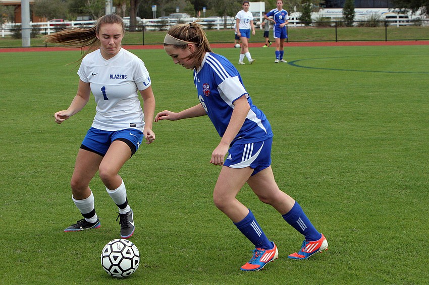 Sarasota Christianâ€™s Cece Gensen, No. 1, and Northside Christianâ€™s Rhea Gilbert, No. 6, fight over the ball.