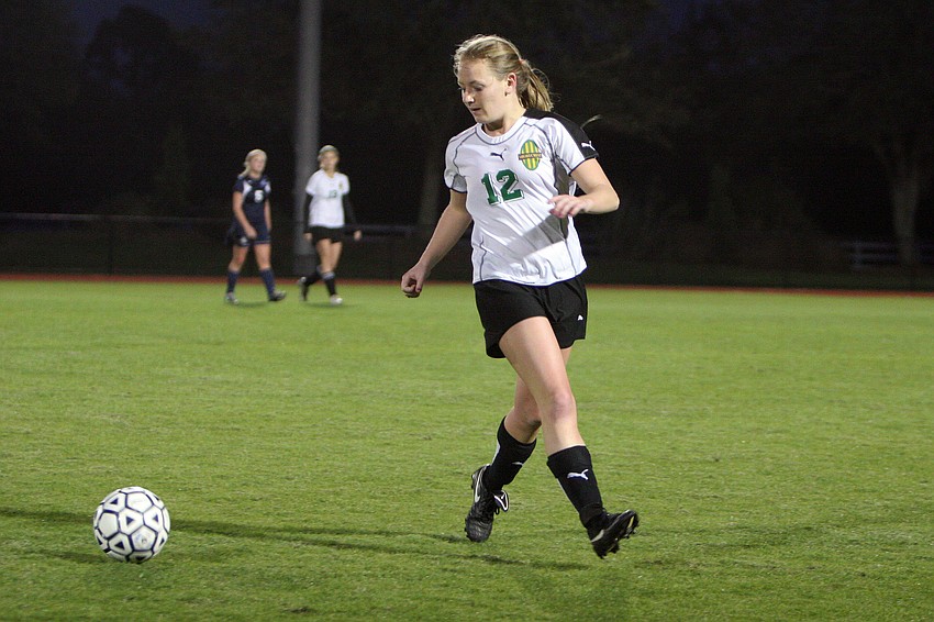 Shorecrest's Julia Brakeman, No. 12, goes to the ball passed by one of her teammates.