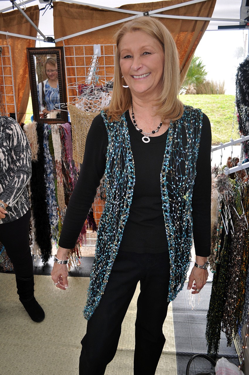 Debbie Alden tries on a vest made by Daniela Viteri.