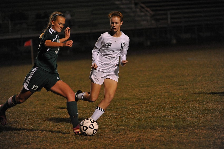 Lakewood Ranch midfielder Megan Hardy, right, battles a Venice player for possession.