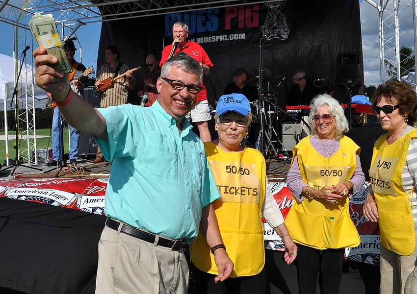 Mark Johnson won $1200 in the 50/50 raffle. He shouted, â€œShow me the money!â€ as he made his way up to claim his winnings.