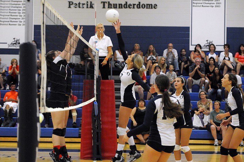 Senior middle blocker Emily Greenwood sends the ball back over the net.