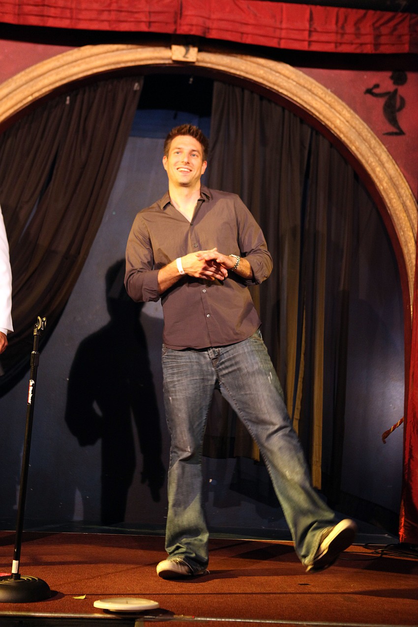 Chris Coffey smiles at the crowd and showed off some impressive dance moves on the run way Tuesday, Sept. 18 during the BYOBachelor Auction.