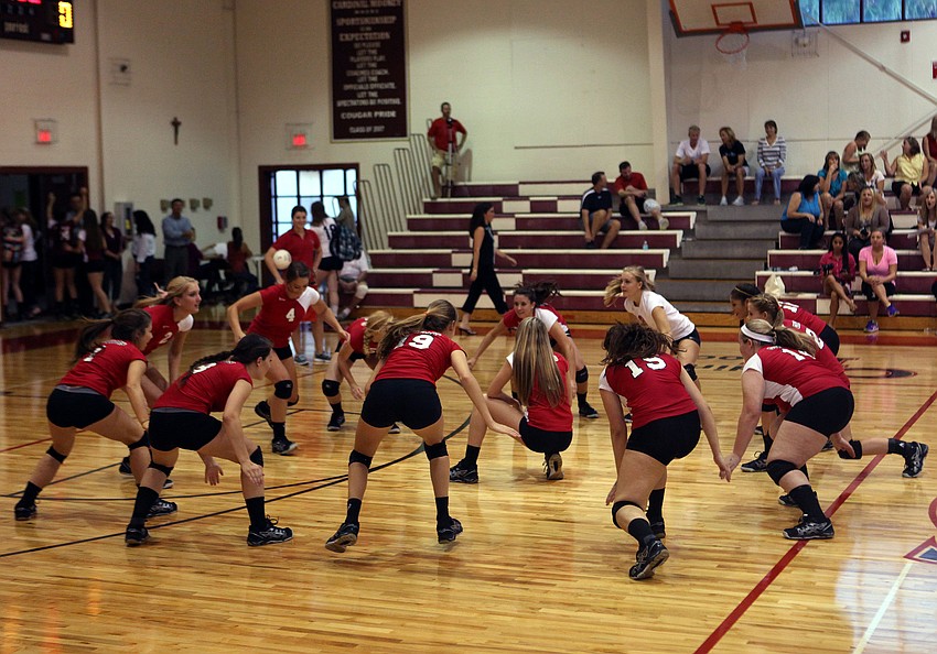 Cardinal Mooney do their team cheer before the start of their game against Out-of-Door Academy Thursday, Sept. 20 at Cardinal Mooney.
