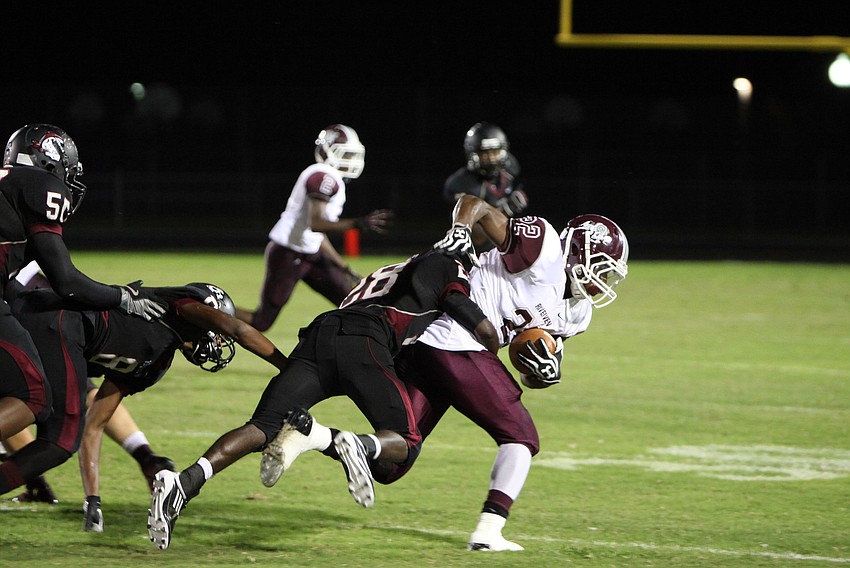 Caleb Ford, No. 28, tackles Karan Higdon, No. 22, Friday, Sept. 21 during the Braden River versus Riverview game at Braden River.