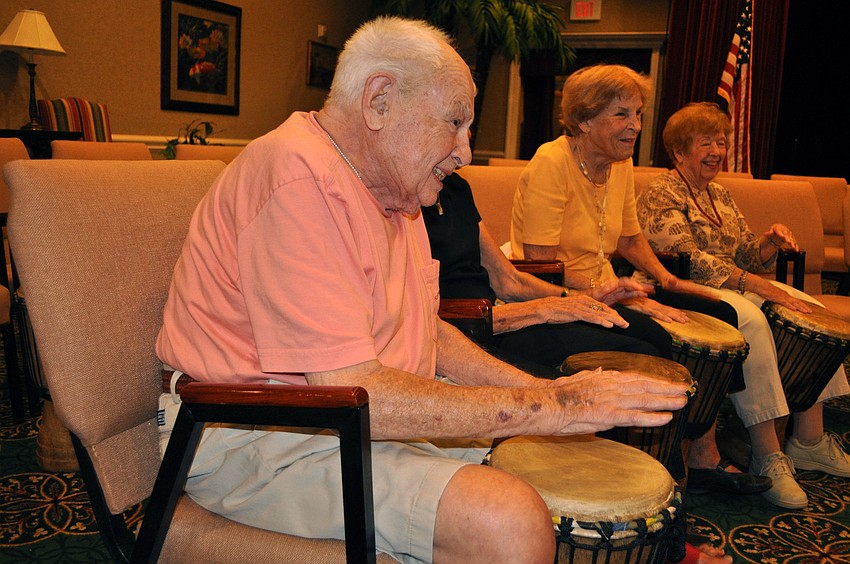 Nate Eisner smiles from ear to ear as he plays on the drum.