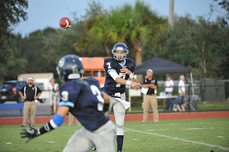 Senior quarterback Evan Wilson throws a shuffle pass to freshman running back J.T. Fischer.