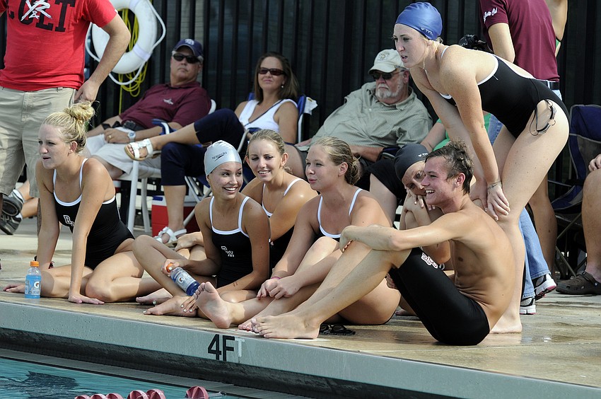Members of the Braden River High swim team cheer on their teammates during a tri-meet Sept. 26 at the Lakewood Ranch YMCA.