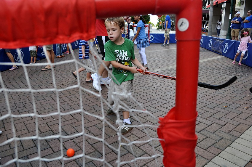 Gavin Egan, 6, slaps a ball into a small goal Saturday, Sept. 29 during the Tampa Bay Lightningâ€™s Rolling Thunder Tour Sarasota stop at Five Points Park.