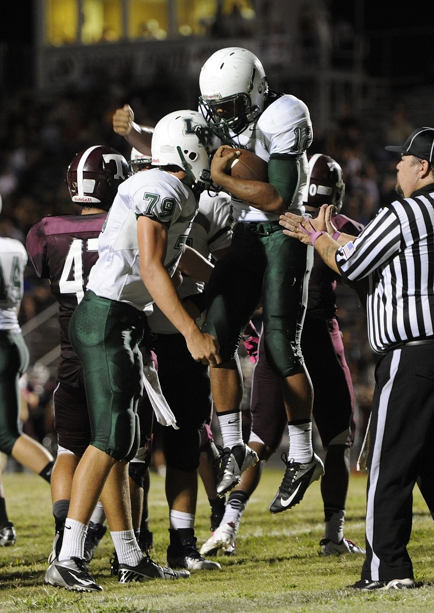 Lakewood Ranch offensive lineman Andrew Staggs congratulates running back Chris Pearcey, right, following his first of four rushing touchdowns on the night.