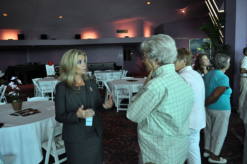 Police chief candidate Bernadette DiPino talks to attendees.