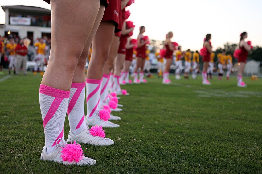 The Cardinal Mooney cheerleaders wore pink and white socks with pink pom poms on their sneakers Friday, Oct. 12, during the Cardinal Mooney homecoming game.