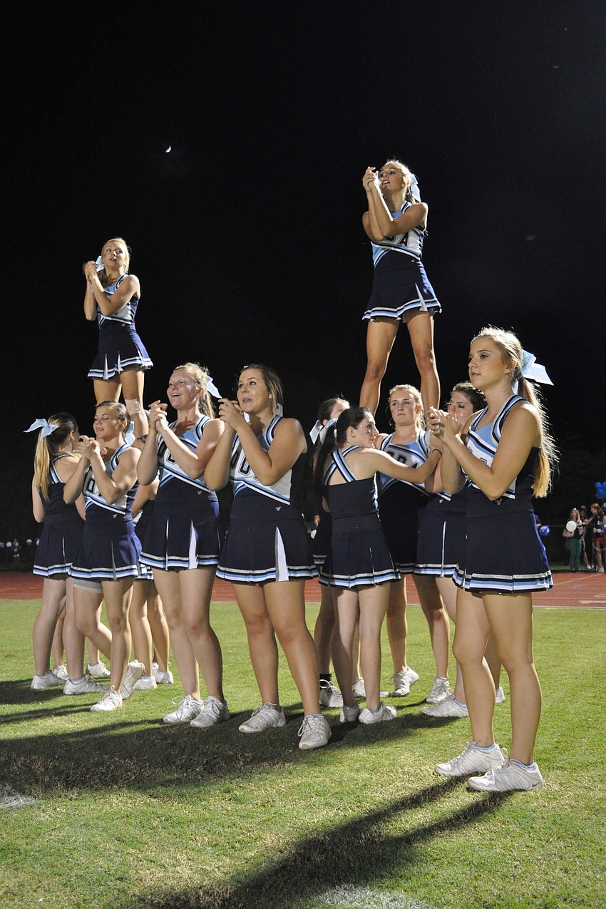 Cheerleaders celebrated touchdowns with stunts along the end zone.